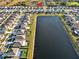 Aerial view of a neighborhood, showcasing a home's location near a large lake at 5456 Logan Cave Ave, Wimauma, FL 33598