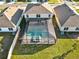 Aerial view of a house with a screened-in pool and spa at 5456 Logan Cave Ave, Wimauma, FL 33598