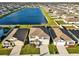 Aerial view showcases homes in a lakeside community at 5456 Logan Cave Ave, Wimauma, FL 33598