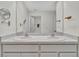 A clean bathroom with double sinks, a large mirror, and modern fixtures, offering a functional and stylish space at 5456 Logan Cave Ave, Wimauma, FL 33598