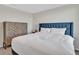 Cozy bedroom with a blue headboard, a decorative cabinet, and carpeted floors create a serene retreat at 5456 Logan Cave Ave, Wimauma, FL 33598
