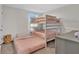 A bedroom featuring a bunk bed and pull-out trundle bed, maximizing space and comfort in a stylish arrangement at 5456 Logan Cave Ave, Wimauma, FL 33598