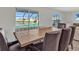 Charming dining area with seating with views of the pool and pond, creating a relaxing space at 5456 Logan Cave Ave, Wimauma, FL 33598