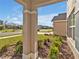 Inviting front porch view with manicured landscaping and a glimpse of the neighborhood at 5456 Logan Cave Ave, Wimauma, FL 33598