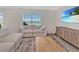 A beautifully staged living room with plush sofas, decorative rug, and large TV creating a cozy and inviting atmosphere at 5456 Logan Cave Ave, Wimauma, FL 33598