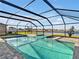 Screened-in pool and spa overlooking a tranquil lake, perfect for relaxation and outdoor enjoyment at 5456 Logan Cave Ave, Wimauma, FL 33598