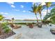 Enjoy outdoor living on this spacious patio with comfortable seating, scenic water views, and tropical landscaping at 6605 Seabird Way, Apollo Beach, FL 33572