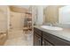 Bathroom featuring a shower-tub combination, wood vanity, neutral countertop and tiled floor at 7001 Interbay Blvd # 181, Tampa, FL 33616