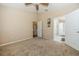Bedroom with carpet, two entry doors, and views into the kitchen and bathroom at 7001 Interbay Blvd # 181, Tampa, FL 33616