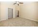 Bedroom with neutral carpet, a ceiling fan, and an open closet at 7001 Interbay Blvd # 181, Tampa, FL 33616