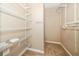 An empty walk-in closet with white metal shelving and neutral colored carpet at 7001 Interbay Blvd # 181, Tampa, FL 33616