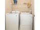 A laundry room equipped with a Samsung washer and dryer and storage shelving at 7001 Interbay Blvd # 181, Tampa, FL 33616