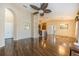 Open floor plan with hardwood floors, decorative ceiling fan, and an archway leading to the dining room at 7001 Interbay Blvd # 181, Tampa, FL 33616