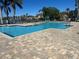 Community swimming pool surrounded by brick pavers, lounge chairs, and lush landscaping at 7001 Interbay Blvd # 181, Tampa, FL 33616
