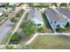 An aerial view of a light blue home with a welcoming porch and beautifully landscaped front yard at 704 Winterside Dr, Apollo Beach, FL 33572