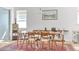 Inviting dining area with natural light, a wooden table, and a stylish accent rug at 704 Winterside Dr, Apollo Beach, FL 33572