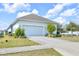 Exterior view of home and driveway with neatly landscaped yard at 704 Winterside Dr, Apollo Beach, FL 33572