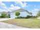 Exterior view of home and driveway with beautiful landscaping at 704 Winterside Dr, Apollo Beach, FL 33572