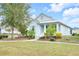 A beautiful home with a well-kept lawn and mature trees in a sunny neighborhood at 704 Winterside Dr, Apollo Beach, FL 33572