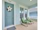 Inviting front porch with seating, charming door, and decorative wreath at 704 Winterside Dr, Apollo Beach, FL 33572