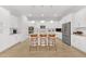 Well-lit kitchen featuring sleek appliances, a large center island, and modern finishes at 704 Winterside Dr, Apollo Beach, FL 33572