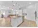 Open-concept kitchen with a center island, pendant lighting, and stainless steel appliances at 704 Winterside Dr, Apollo Beach, FL 33572