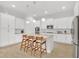 Elegant kitchen featuring white cabinetry, a center island, and modern pendant lights at 704 Winterside Dr, Apollo Beach, FL 33572