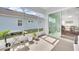 Bright enclosed sun room with grill and seating area at 704 Winterside Dr, Apollo Beach, FL 33572
