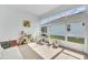 Sunny, enclosed sun room features furniture, potted plants, and room to relax at 704 Winterside Dr, Apollo Beach, FL 33572