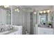 Bright bathroom showcasing a glass-enclosed shower, double vanity, and modern lighting at 757 Steel Dr, Apollo Beach, FL 33572