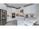 Modern kitchen with white cabinetry, stainless steel appliances, and granite countertops at 757 Steel Dr, Apollo Beach, FL 33572