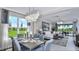 Bright and airy living room with a modern chandelier and views of the landscaped yard at 757 Steel Dr, Apollo Beach, FL 33572