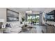 Cozy living room with elegant chandelier, comfortable white couch, and view of the lanai at 757 Steel Dr, Apollo Beach, FL 33572