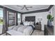 Comfortable bedroom featuring a decorative headboard, modern ceiling fan, and natural light at 757 Steel Dr, Apollo Beach, FL 33572