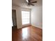 Bright bedroom features hardwood floors, natural light from a large grid window, and a ceiling fan at 8728 Mallard Reserve Dr # 102, Tampa, FL 33614