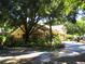 Exterior view of a clubhouse featuring lush landscaping and mature trees at 8728 Mallard Reserve Dr # 102, Tampa, FL 33614