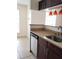 The kitchen features stainless steel appliances, dark cabinetry, and a breakfast bar at 8728 Mallard Reserve Dr # 102, Tampa, FL 33614