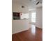 Open living space with hardwood floors, a breakfast bar, and natural light at 8728 Mallard Reserve Dr # 102, Tampa, FL 33614