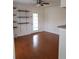 Bright living room with hardwood floors, ceiling fan, and access to a private balcony at 8728 Mallard Reserve Dr # 102, Tampa, FL 33614