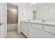 Bathroom featuring double sink vanity and bath shower combination with tile surround at 10356 Cross River Trl, Parrish, FL 34219