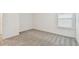 Bedroom featuring neutral carpet and white walls, illuminated by a window at 10356 Cross River Trl, Parrish, FL 34219