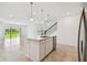 Kitchen with island sink, stainless steel dishwasher and large sliding glass door to backyard at 10356 Cross River Trl, Parrish, FL 34219