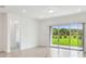 Bright, empty living room with sliding glass doors to the backyard at 10356 Cross River Trl, Parrish, FL 34219