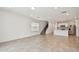 Spacious living area with open floor plan to kitchen and staircase to upper level at 10356 Cross River Trl, Parrish, FL 34219