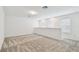 Open loft space with neutral carpet, white walls, and natural light from multiple windows at 10356 Cross River Trl, Parrish, FL 34219