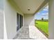 Covered patio featuring a paved surface and view of the backyard at 10356 Cross River Trl, Parrish, FL 34219
