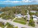 An aerial view showcases the proximity of a residential property to the bay in a lush, green neighborhood at 1044 Charles St, Clearwater, FL 33755