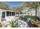 Spacious backyard featuring a patio area with dining table and a well-maintained lawn at 1044 Charles St, Clearwater, FL 33755