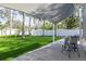 Shaded patio area with a seating area, surrounded by a lush lawn at 1044 Charles St, Clearwater, FL 33755