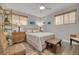 Bright bedroom features wood-look floors, ceiling fan, and two windows at 1044 Charles St, Clearwater, FL 33755